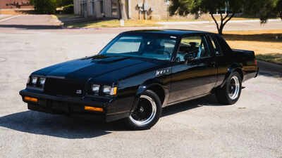 inside the gnx remains unmistakably rooted in its era a three spoke leather wrapped steering wheel sits ahead of gnx specific stewart warner instrumentation