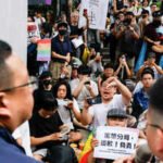 people march and protest after police raided a gay bar in taipei