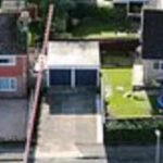 the priest was also filmed sprinkling holy water along the fence separating their homes property photo google maps